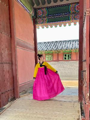 Sammy Segeda '23 stands in a doorway in South Korea in traditional dress.